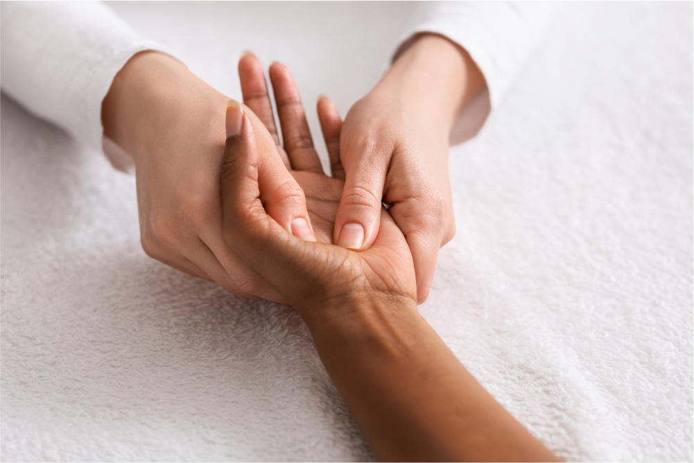 female hands getting massaged by a reflexologist